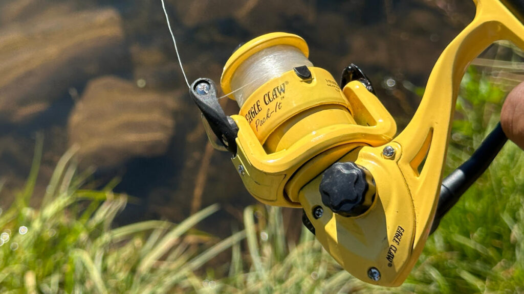 Close up of Eagle Claw Pack-It spinning reel spool with monofilament line